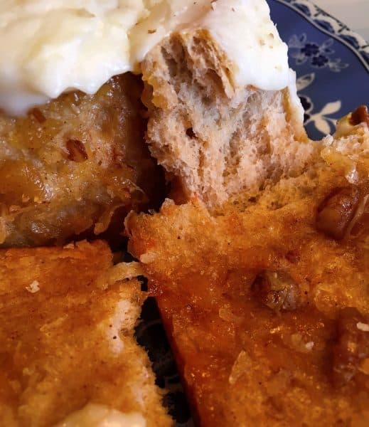 Close up photo of carrot cake cinnamon rolls pulled apart to show filling.