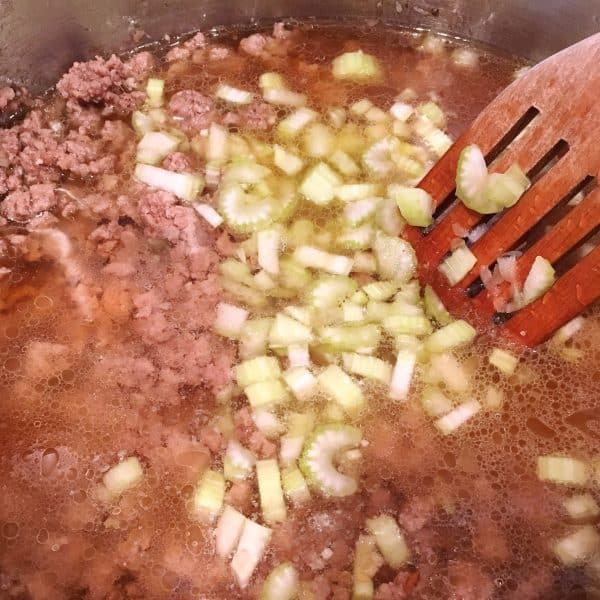 Ground Beef with celery and broth in pot