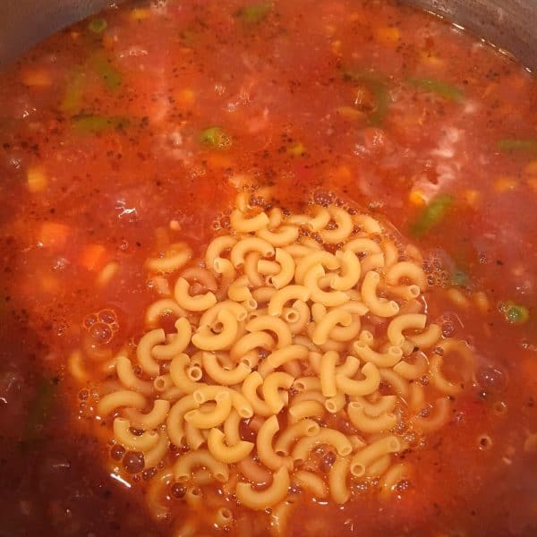 Adding macaroni to soup