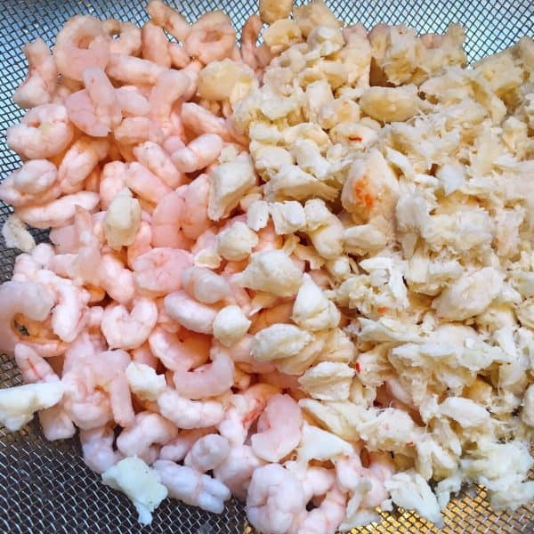 Straining shrimp and lump crab meat for Seafood Pasta Salad