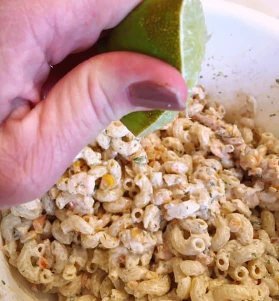 Squeezing Lime into Mexican Seafood Pasta Salad.
