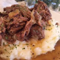 Mississippi Pot Roast and Gravy on a bed of garlic cheddar mashed potatoes