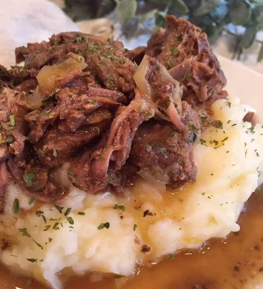 Mississippi Pot Roast and Gravy on a bed of garlic cheddar mashed potatoes