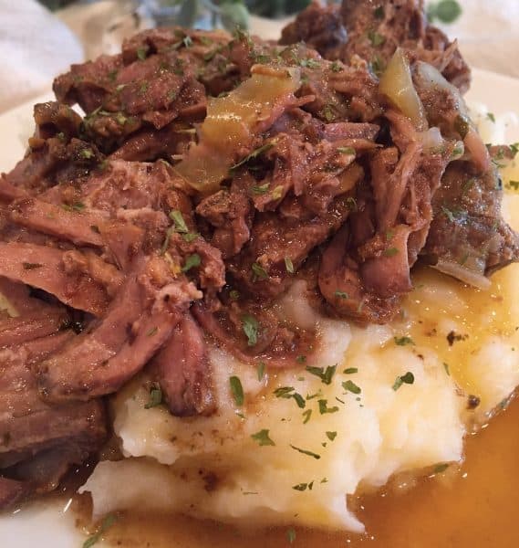 Mississippi Pot Roast with Gravy on a bed of Garlic Cheddar Mashed Potatoes
