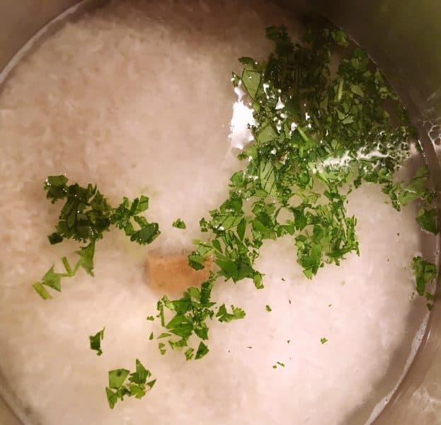 Sauce pan with water, chicken bullion, and cilantro for Cilantro Lime Rice