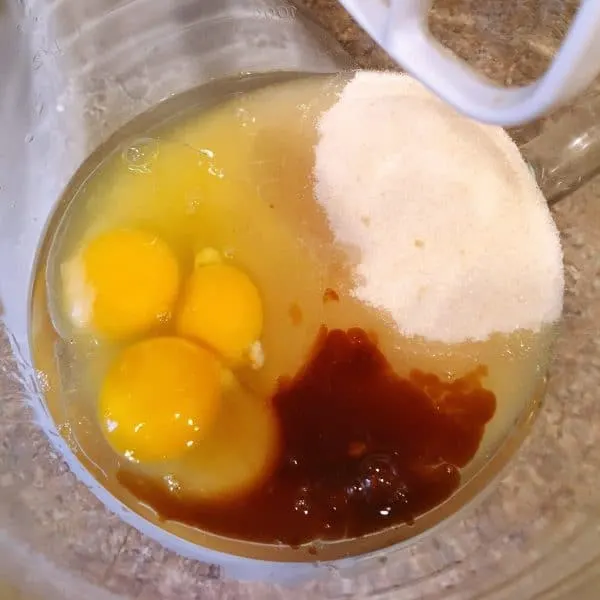 Mixing bowl with eggs, vanilla, sugar and oil