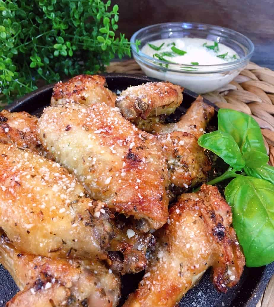 Air Fryer Parmesan Wings on a iron skillet with dipping sauce