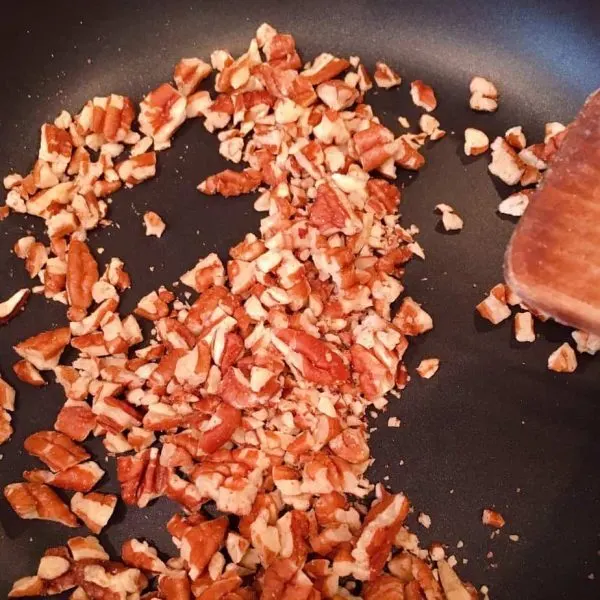 Chopped pecans in skillet over medium heat. Toasting.