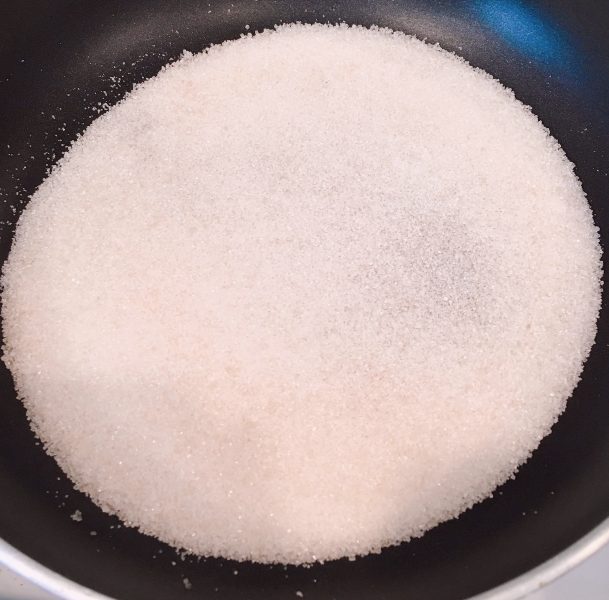 Sugar in the skillet for candied pecans.