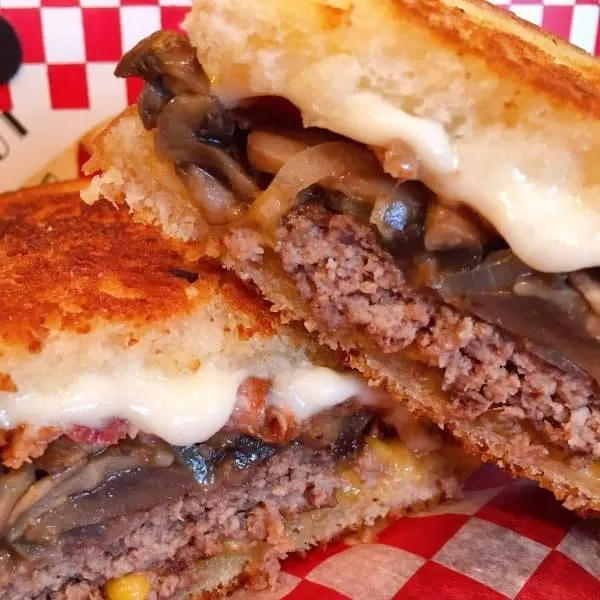 Ultimate Patty Melt put together and cut in half.