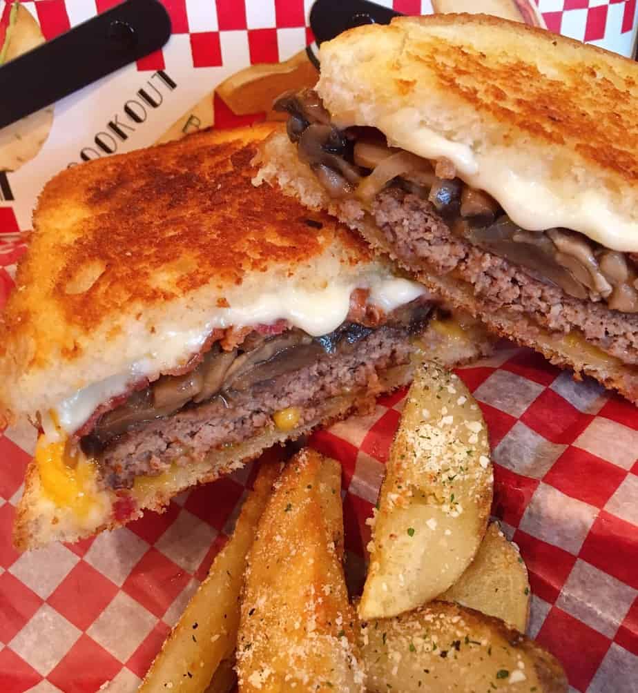 Ultimate Patty Melts on checkered paper with wedge fries