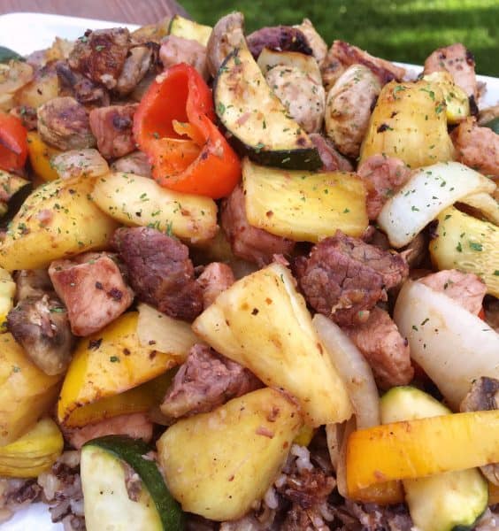 Plated Steak & Pork Unkabobs on a bed of wild rice