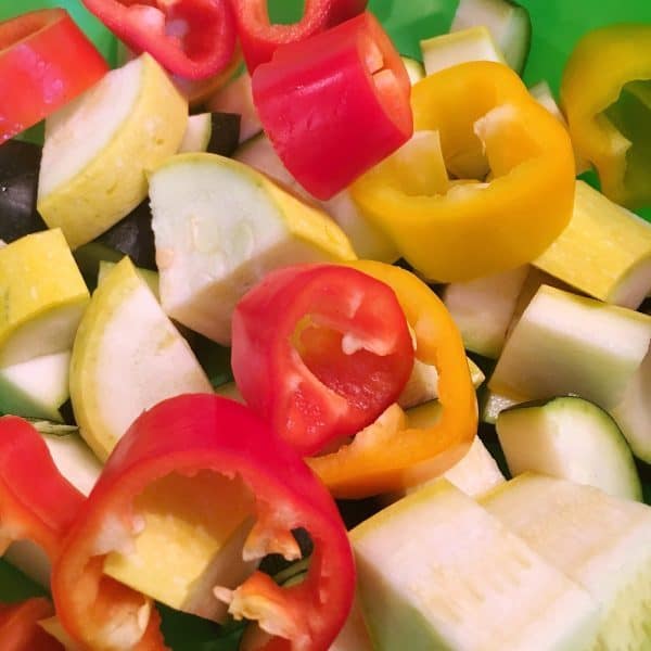 bowl full of cut up peppers and squash