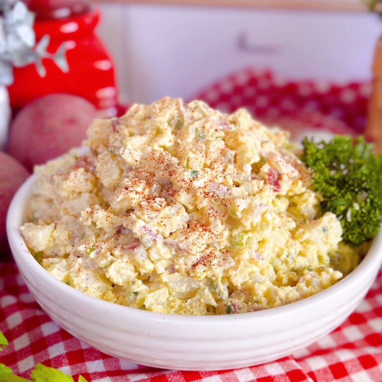 Classic Potato Salad made with red potatoes and garnished with parsley.