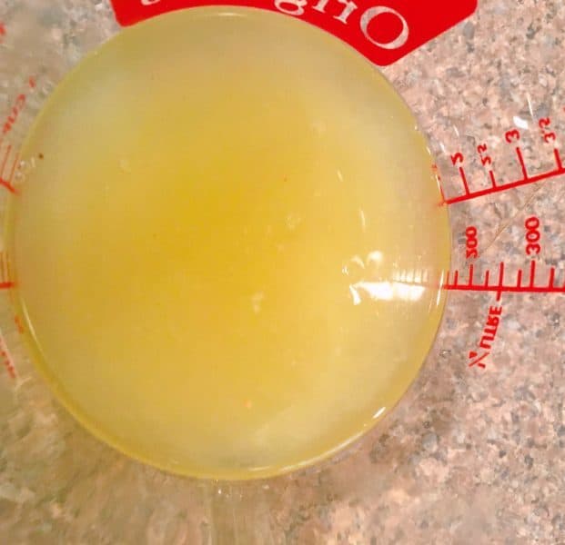 Fresh squeezed lemon juice in a measuring cup