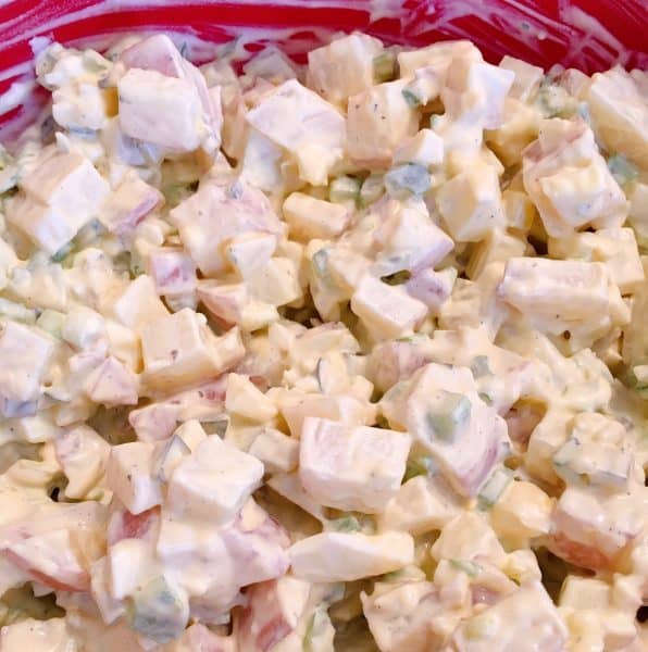 Mixed potato salad ingredients in large bowl