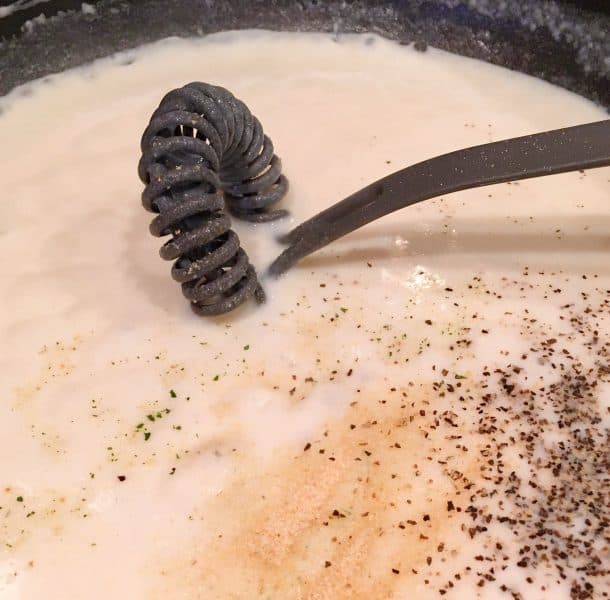 adding milk and seasonings to flour and butter mixture