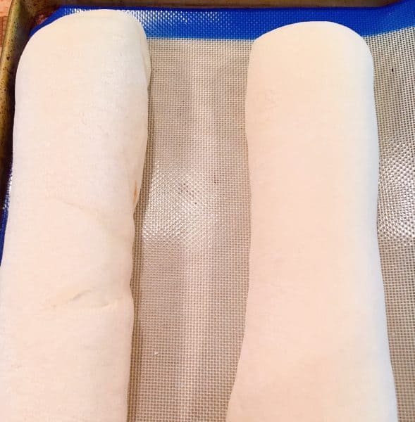 loaves of bread on a silicone lined baking sheet.