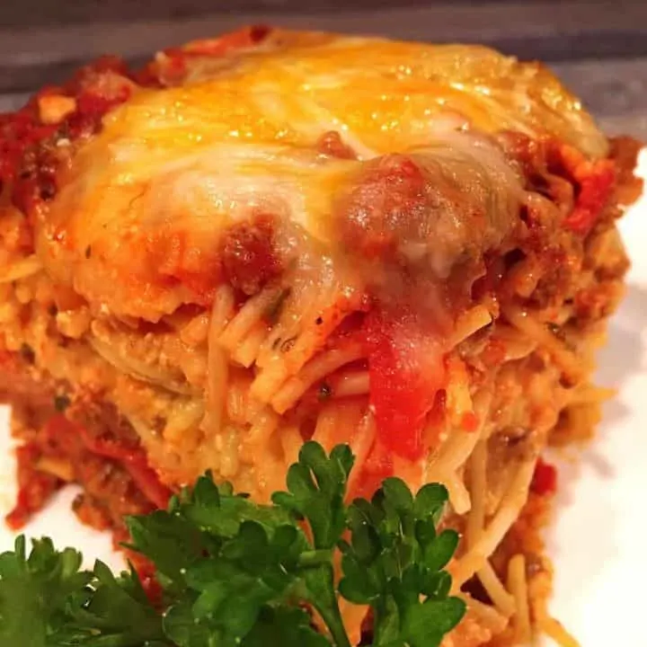 Meat Lover Baked Spaghetti cut and on a plate ready to eat.