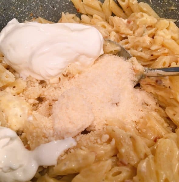 Addition of Parmesan Cheese and sour cream to pasta mixture