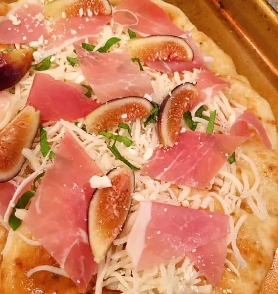 Place sliced figs on the pizza