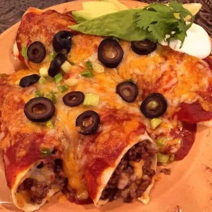 Easy Ground Beef Enchiladas on a plate ready to eat.