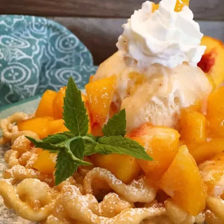 Peaches and cream funnel cake with a scoop of ice cream