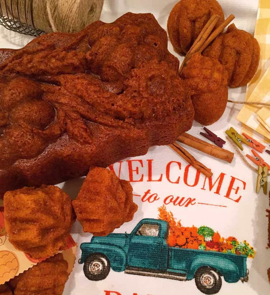 Moist Pumpkin bread loaf and muffins on a cute Fall dish towel