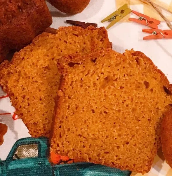 Two slices of moist pumpkin bread on a mat