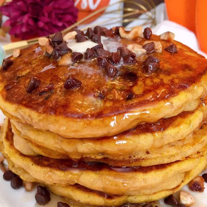 Tall stack of Pumpkin Chocolate Chip Pancakes with Maple Syrup