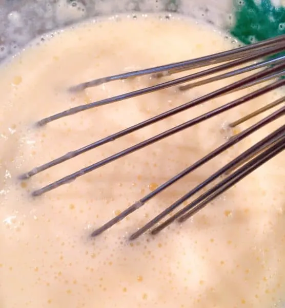 Whisking melted butter into cold milk mixture