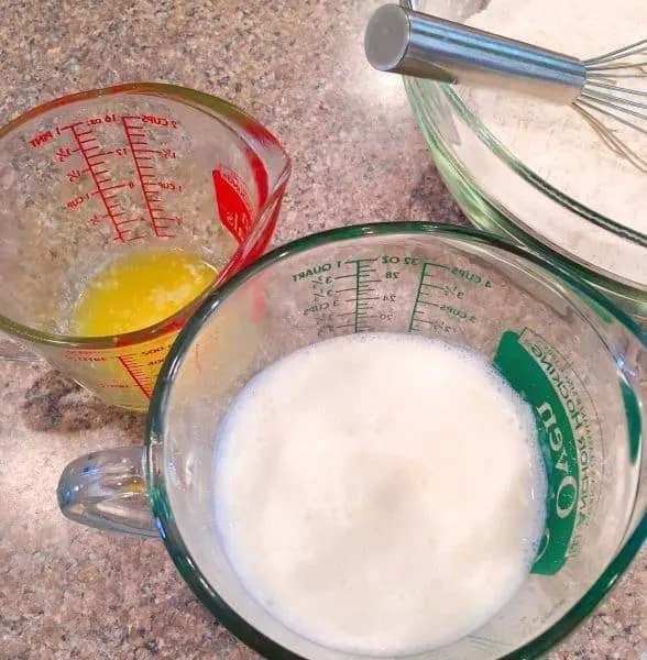 Milk and melted butter in measuring cups
