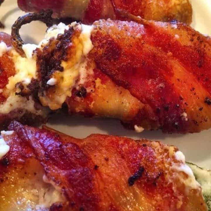 Stuffed fresh jalapeno peppers with cream cheese wrapped in bacon.