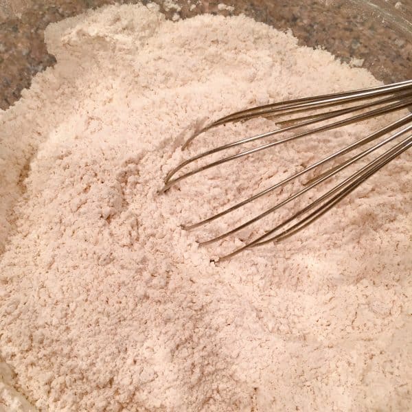 Whisking flour and spices in a large bowl