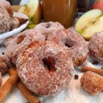 Group of Apple Cider Donuts with Apple Cider and apples