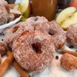 Group of Apple Cider Donuts with Apple Cider and apples