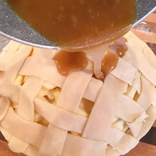 Caramel sauce poured over lattice top of crust.