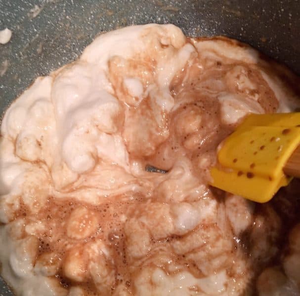 Marshmallows and vanilla added to melted butter on stove