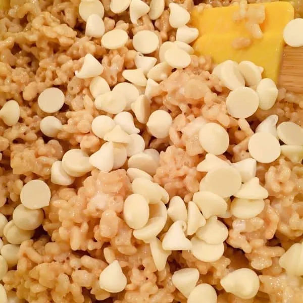 Adding white chocolate chips to rice krispie mixture