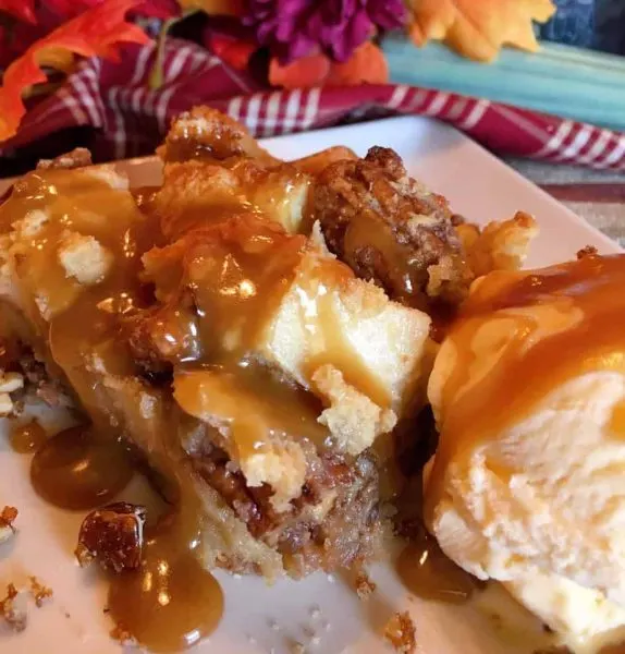 Pecan Pie Bread Pudding with Salted Caramel Sauce and a scoop of vanilla ice cream.