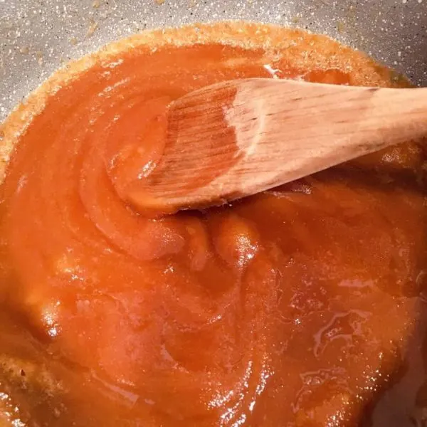 brown sugar in melted butter being stirred until dissolved.