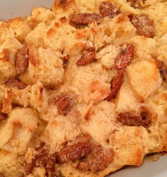 Baked Pecan Pie Bread Pudding in baking dish cooling on counter