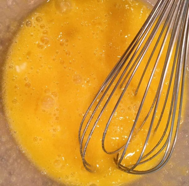 Eggs and sugar mixed in a bowl.