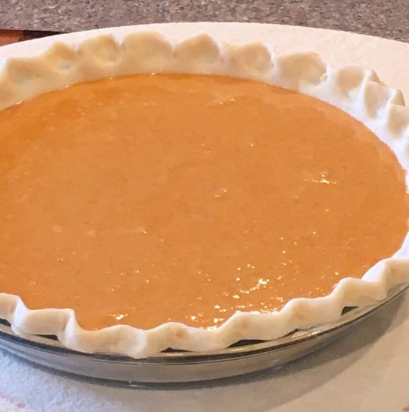 pie filling poured into pie crust.