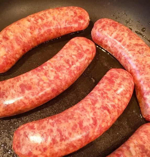 Italian Sausage in a skillet with olive oil