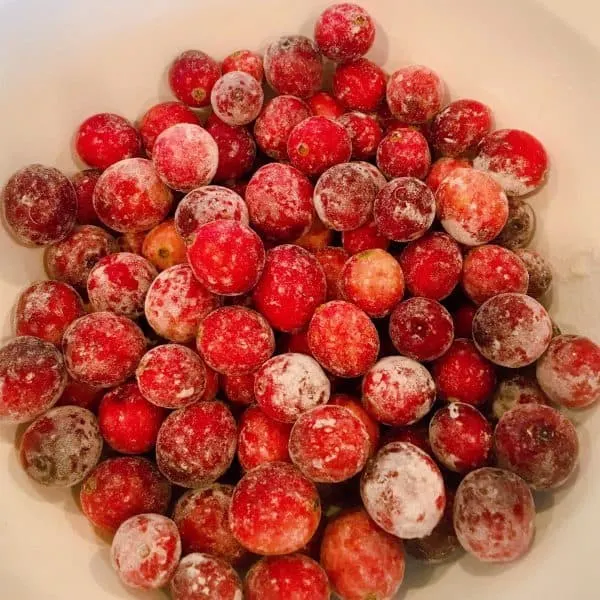 tossing cranberries with flour