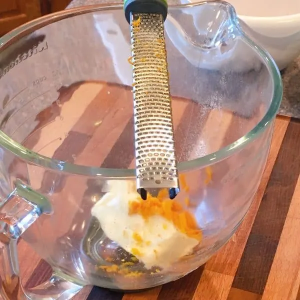 zesting one orange into mixing bowl