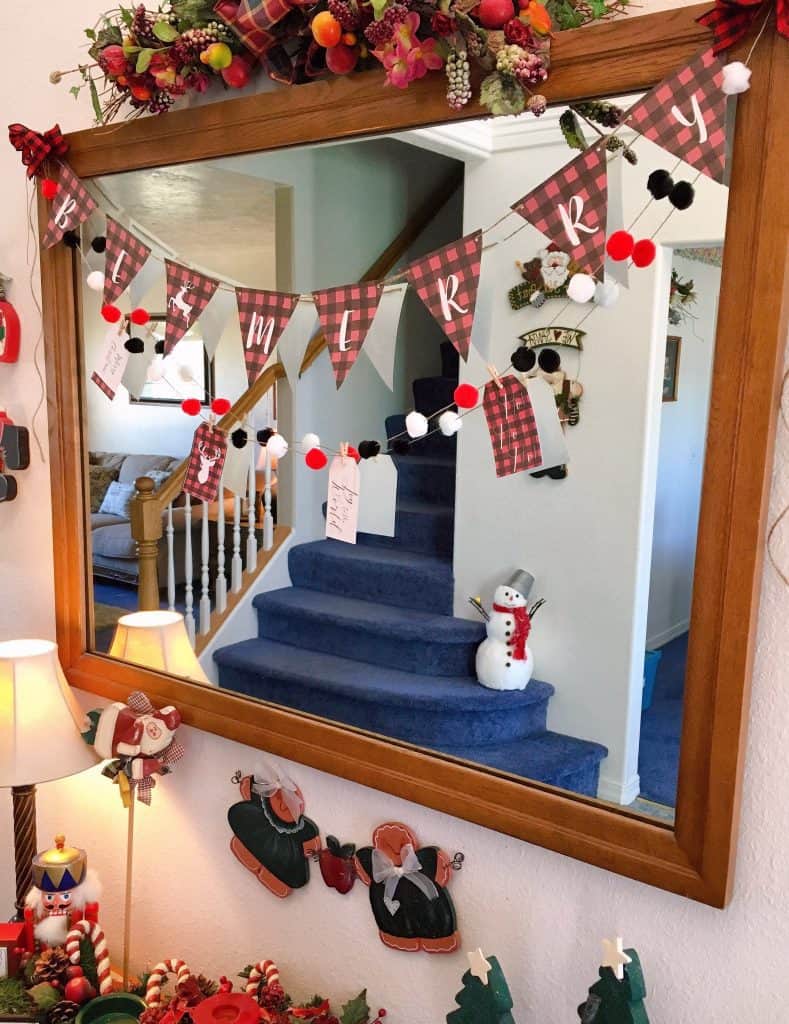 Pom-pom banner with the Be Merry Banner hanging in my entry way