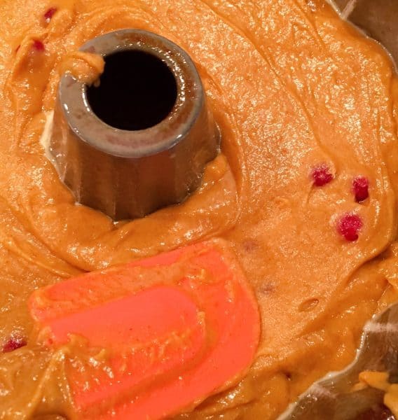 Spreading cake batter in prepared bundt pan