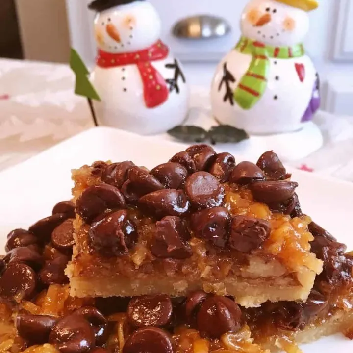 Easy Chocolate Caramel-Pecan Bars stacked on a plate.